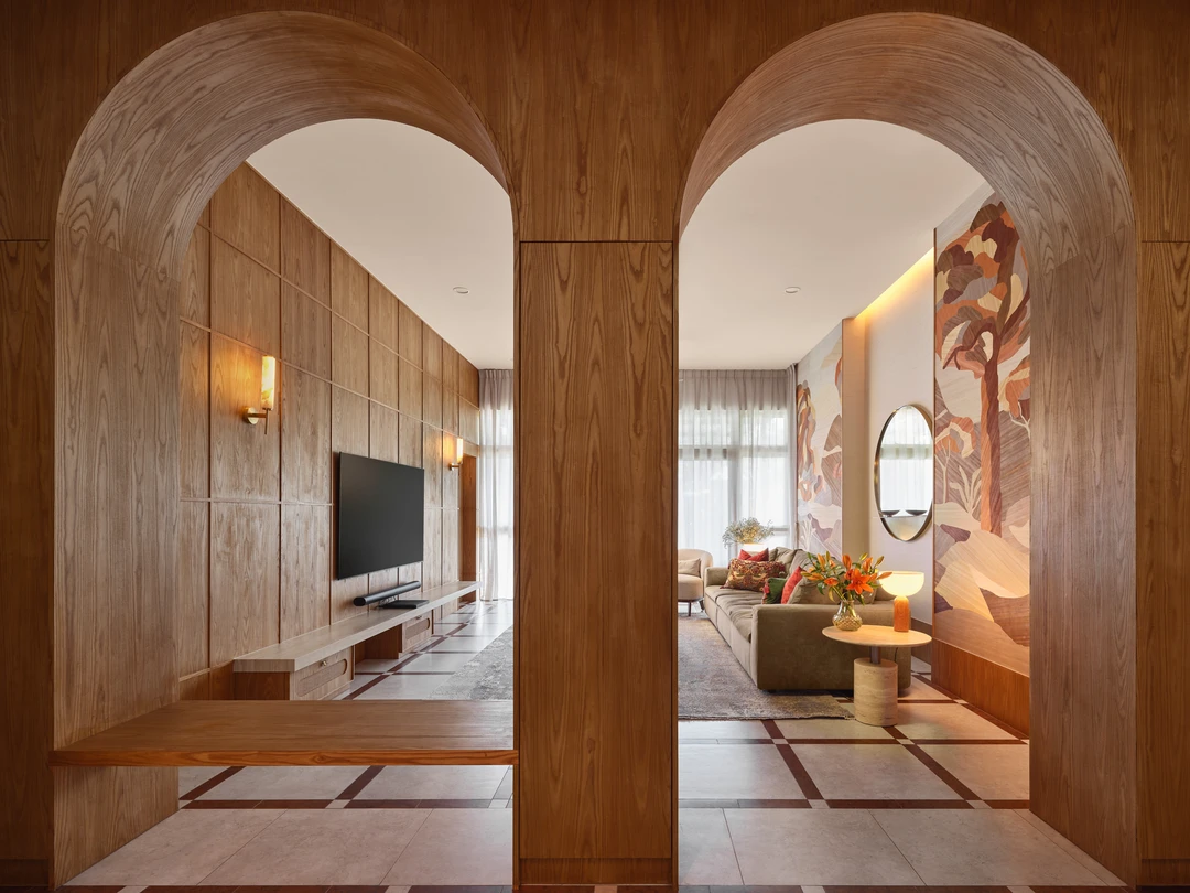 Bayshore residence by Nidhi Jain with timber arch portals framing the living and dining areas, crop detail