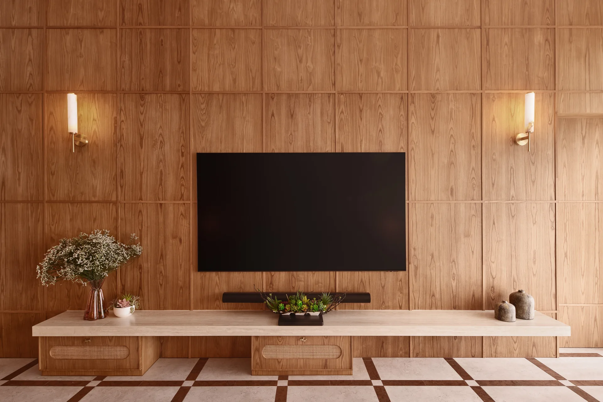 Bayshore residence TV wall by Nidhi Jain with timber paneling, wall sconces and low console joinery, crop detail