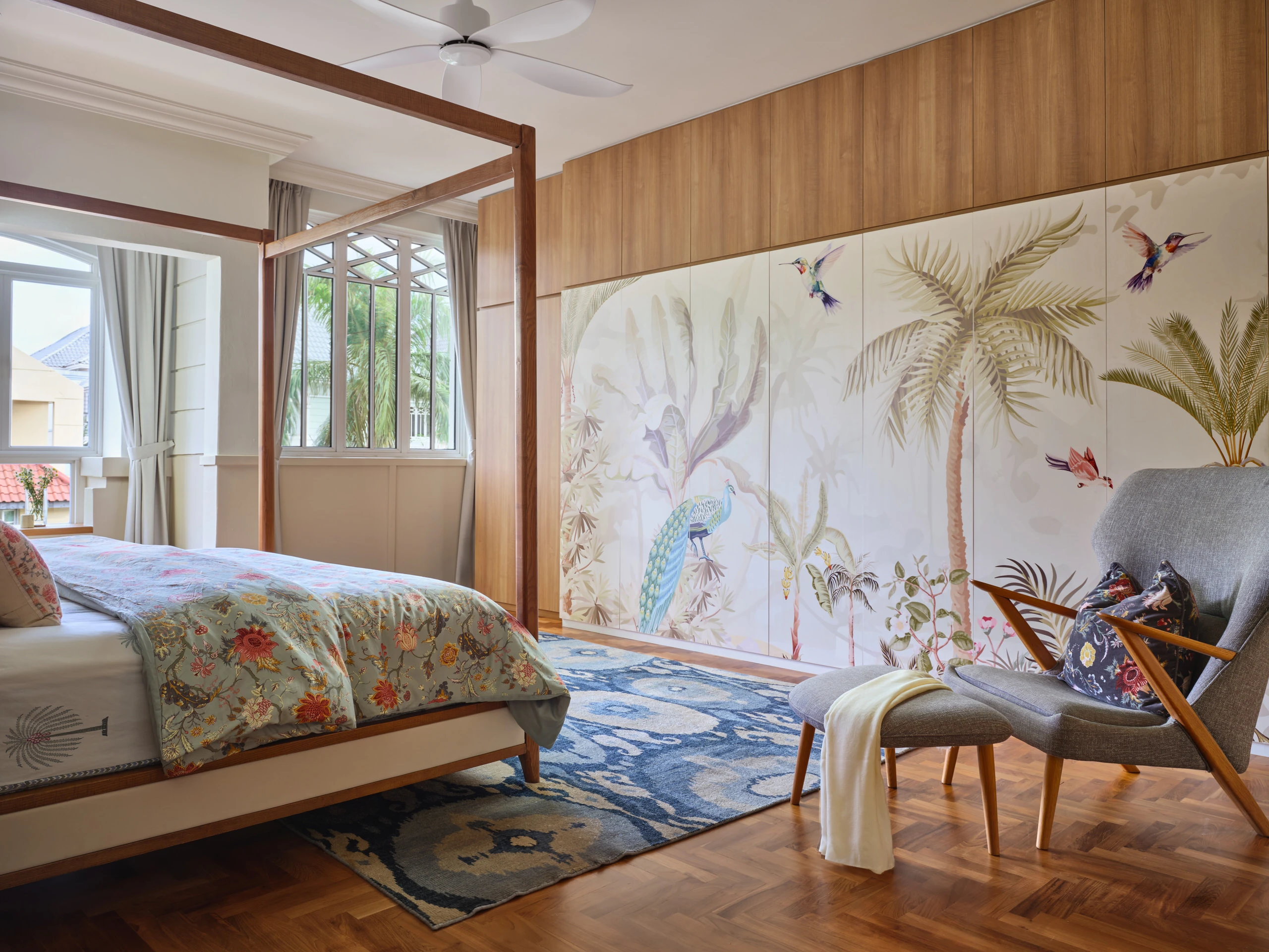 Bedroom with tropical wall mural, wooden bed frame and natural light