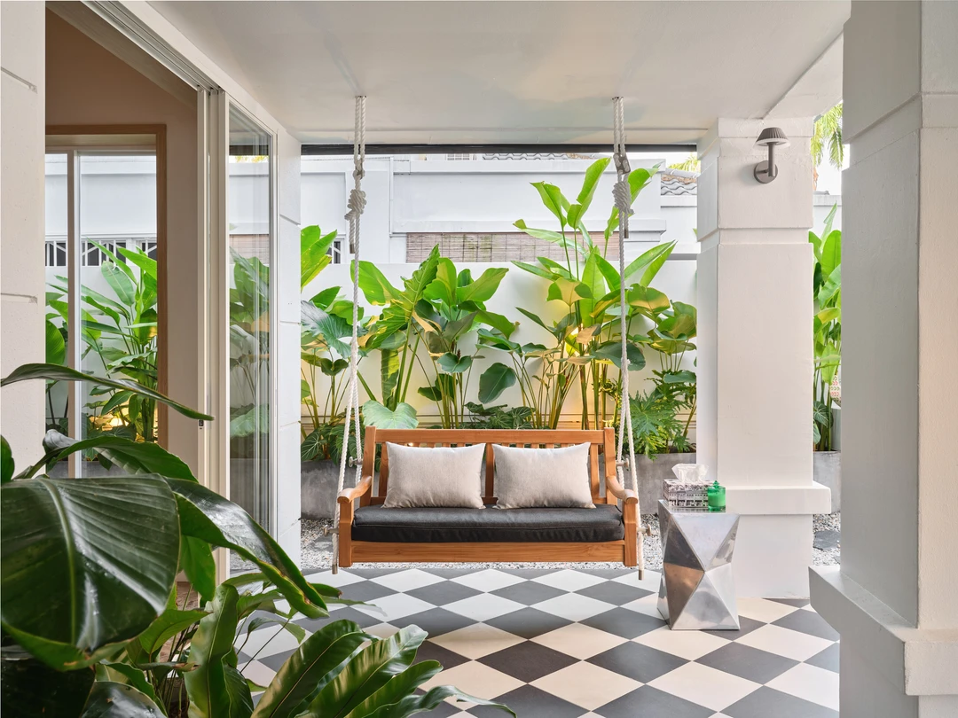 Garden swing seat surrounded by lush tropical greenery