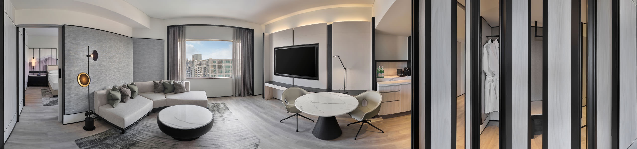 360 panorama of Hilton Singapore Orchard one-bedroom suite living area with L-shaped sofa and city views