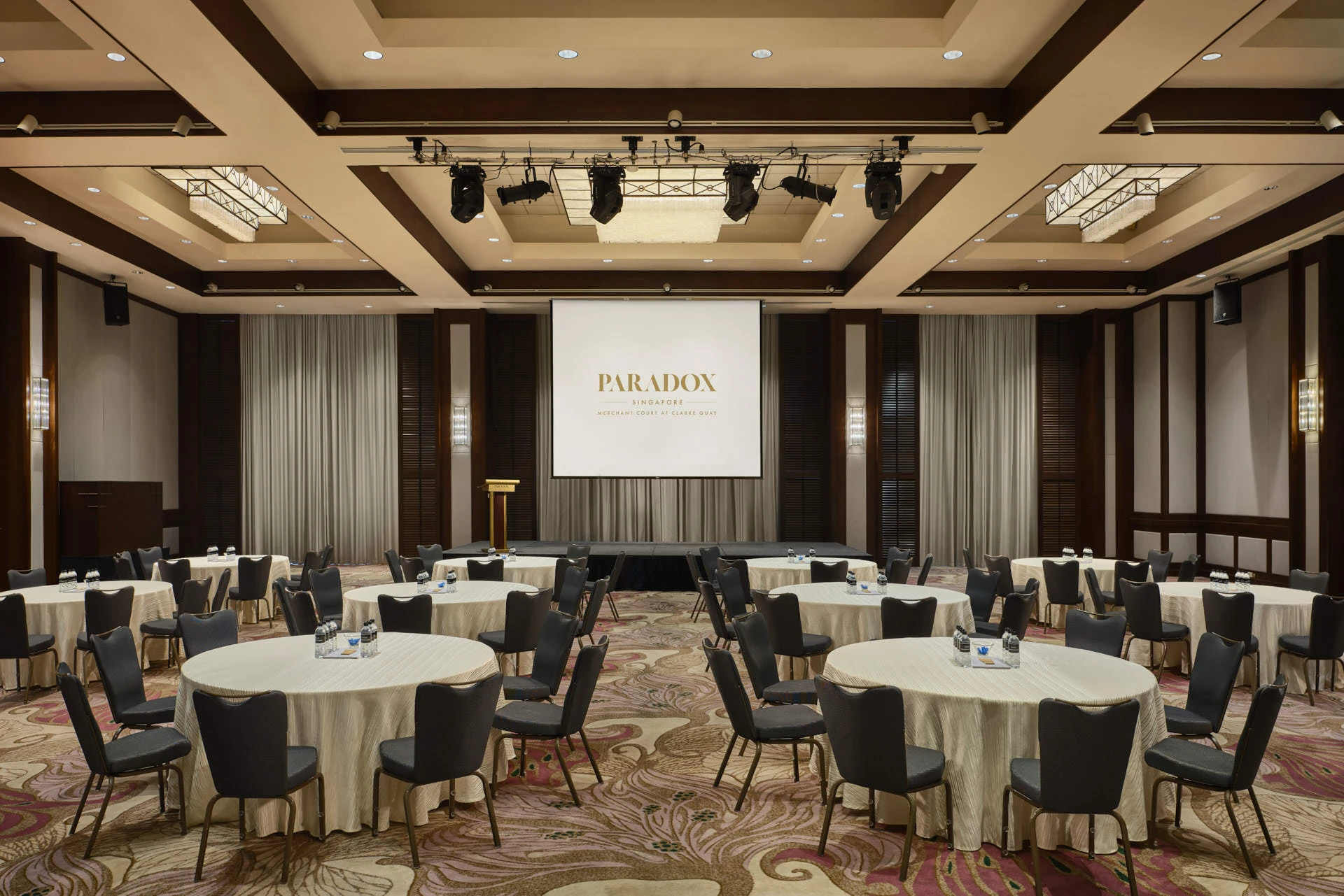 Corporate seminar with round tables and branded projection screen - Paradox Singapore function room photography