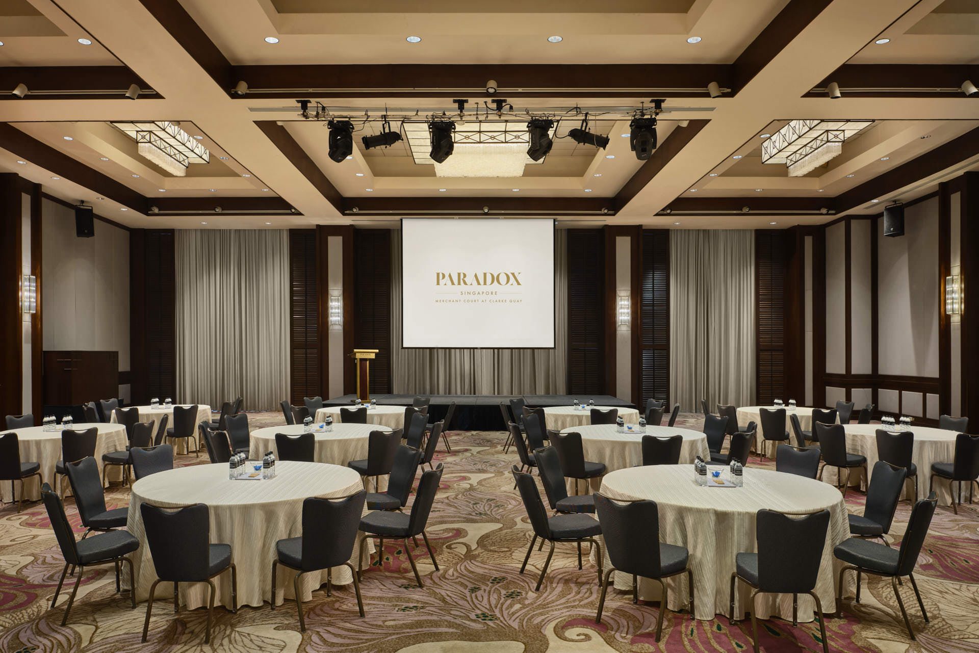 Corporate seminar with round tables and branded projection screen - Paradox Singapore function room photography