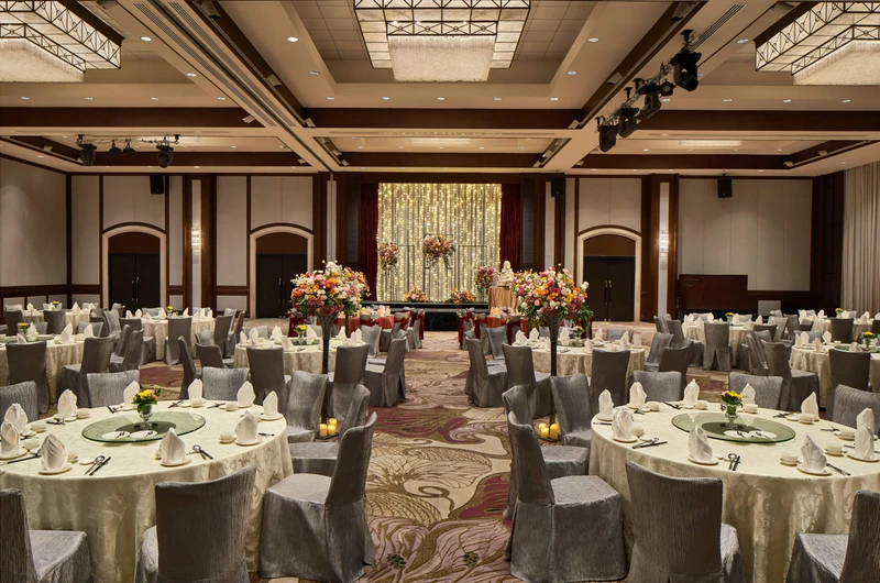 Paradox Singapore ballroom wedding banquet with ivory linens, floral aisle, and fairy-light backdrop