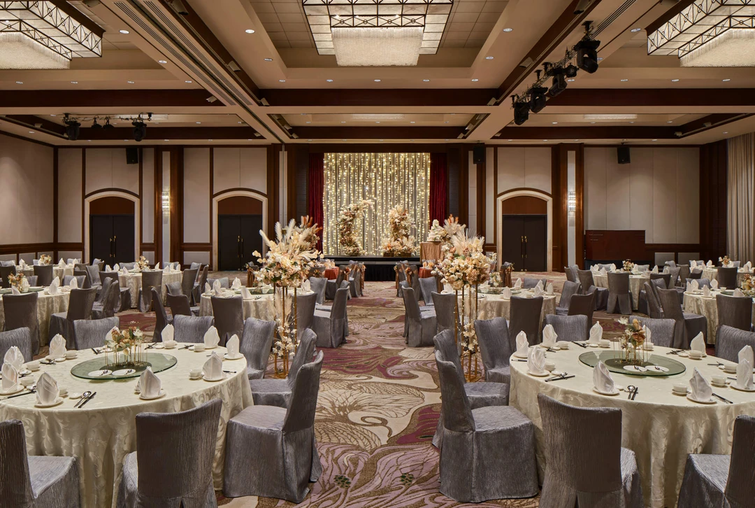 Paradox Singapore bohemian wedding setup with pampas grass, cream blooms, and fairy-light stage
