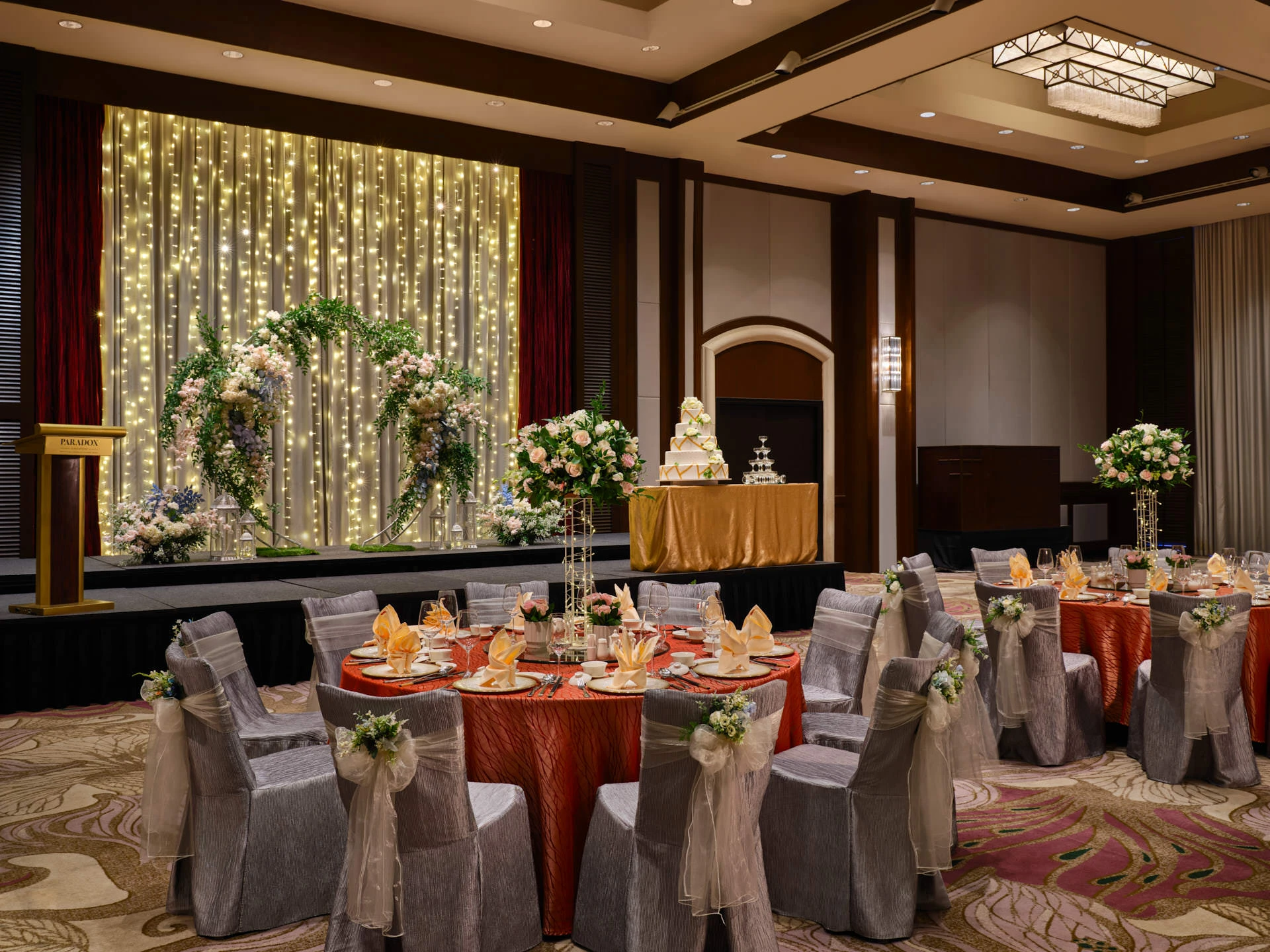 Garden-inspired wedding with coral linens, organza bows and pastel flowers - Paradox Singapore ballroom photography