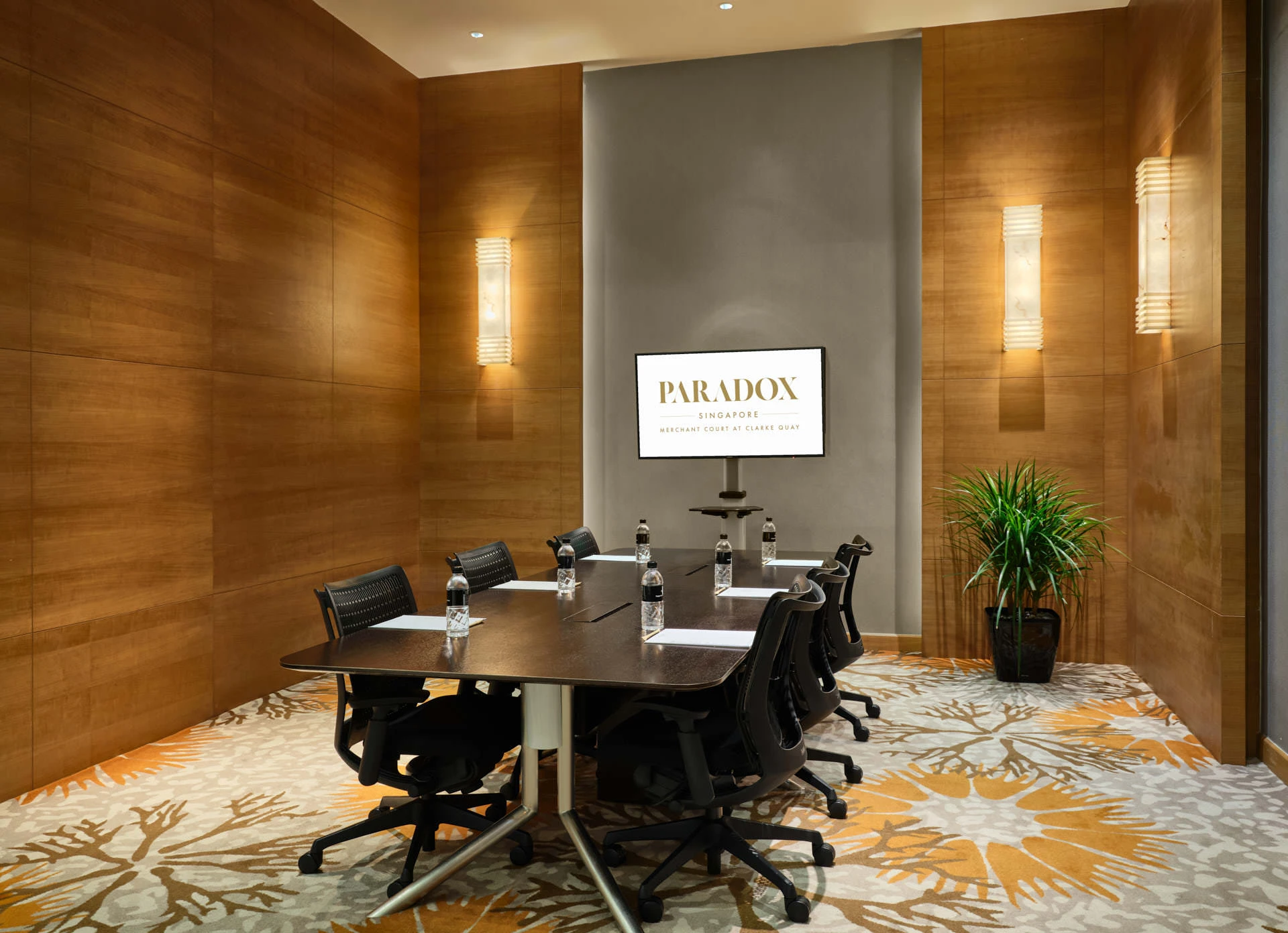 Intimate boardroom with Art Deco sconces and wood panelling - Paradox Singapore meeting room photography