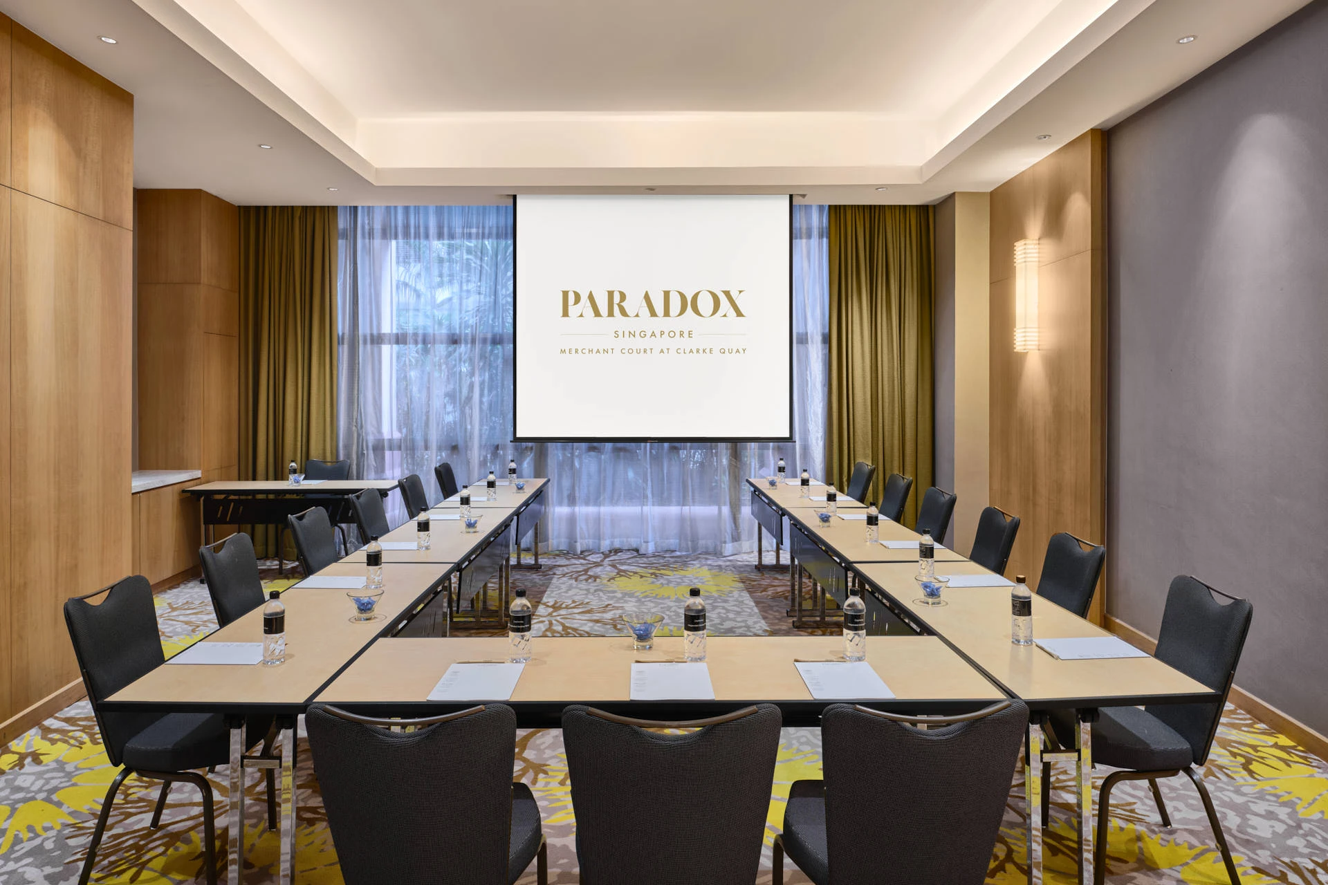 U-shape meeting room with natural light and olive curtains - Paradox Singapore function room photography