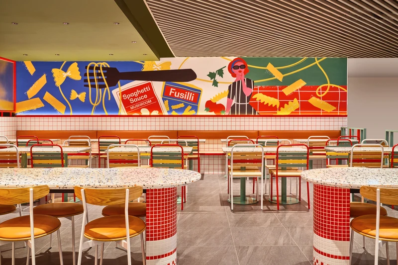 Pop-art mural with leather banquette and terrazzo drum base tables at PastaMania Causeway Point