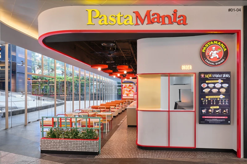 Retro booth seating with leather bolsters and mint pedestal legs at PastaMania Fusionopolis