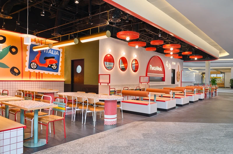 Full dining hall with red disc pendants, terrazzo tables and Italian colour story at PastaMania Fusionopolis