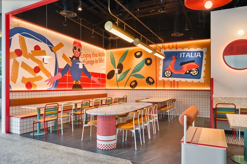 Dining area with Vespa mural, terrazzo mosaic tables and pendant lights at PastaMania Fusionopolis