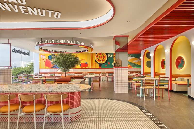 Bar counter view across full restaurant with mosaic floor lettering and ceiling ring at PastaMania Northpoint