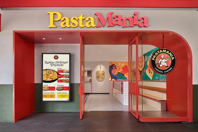 Red archway entrance with digital menu board and colourful interior at PastaMania Sengkang