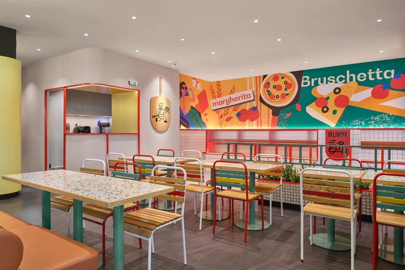 Pop-art inspired dining with colourful chairs, mural wall and order counter at PastaMania Sengkang