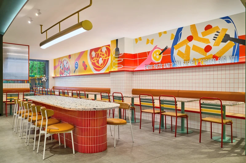 Communal dining with mural wall, grid tile wainscoting and brass track lighting at PastaMania Tampines