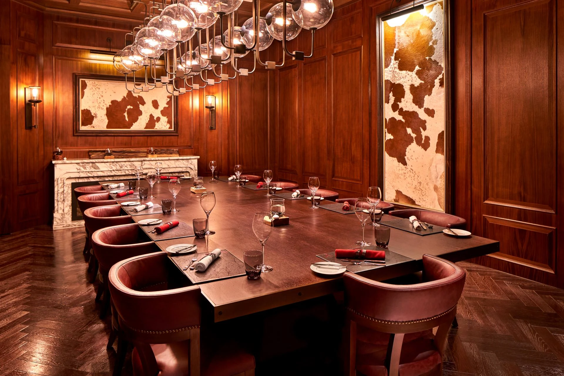 U-shaped private dining with marble fireplace and glass-bubble chandelier