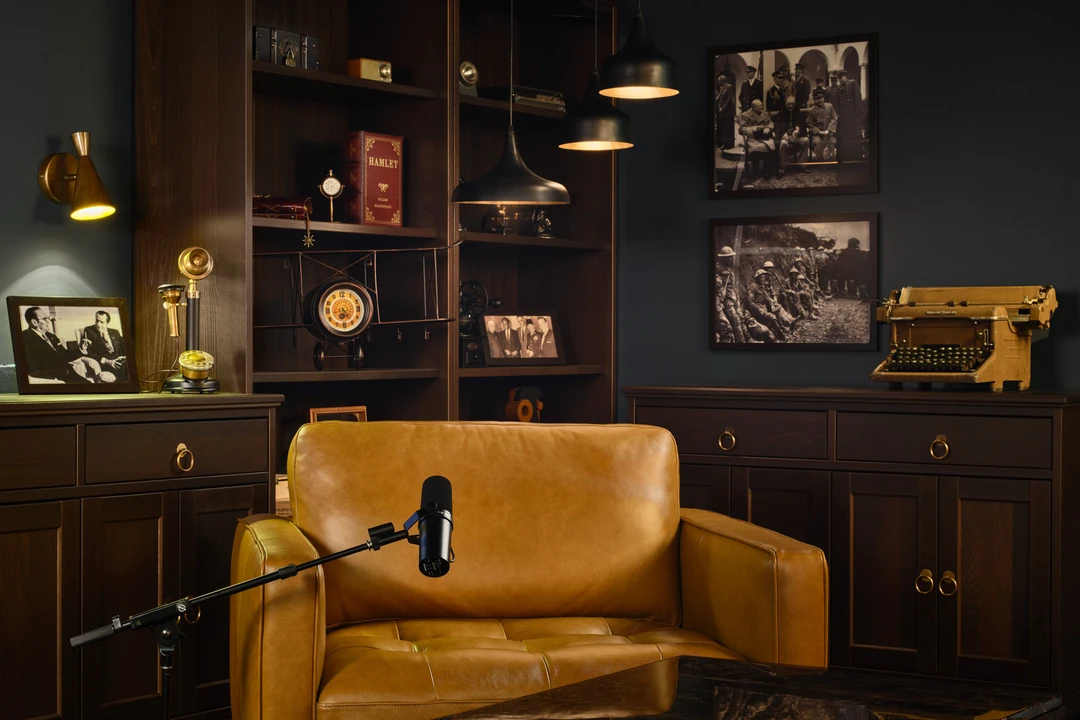 Library studio detail with cowhide rug, chest table and globe bookshelf