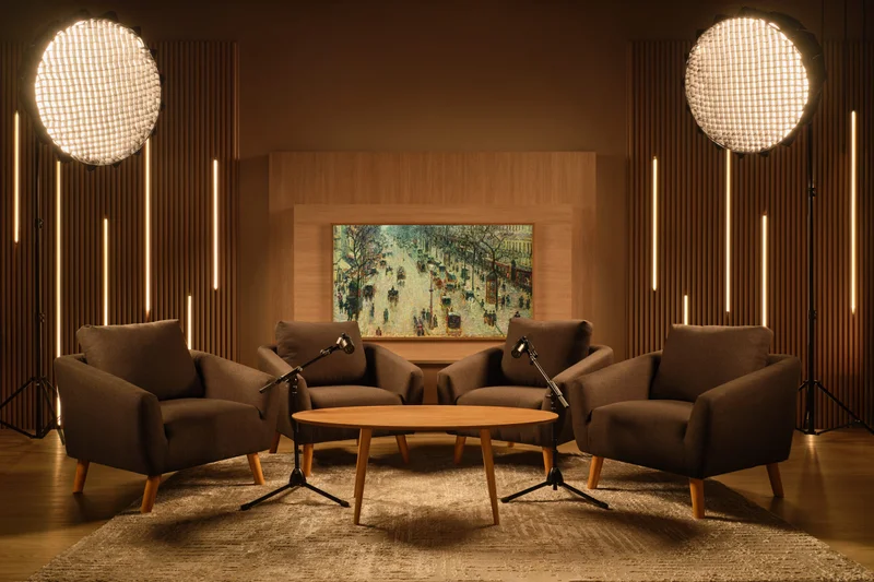 Mid-century modern podcast studio with wood slat panels and art display