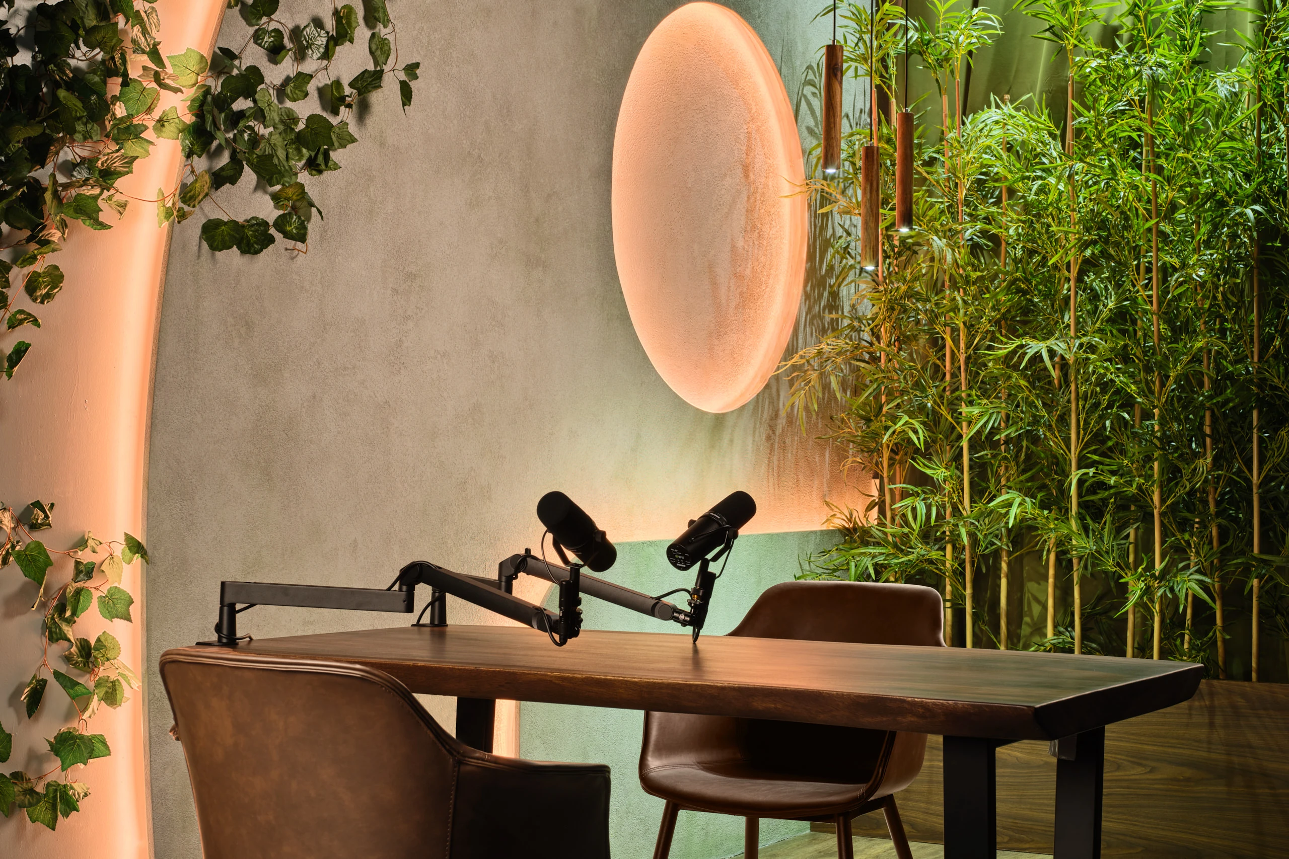 Botanical studio detail with vine wall, wave LED element and moon sconce