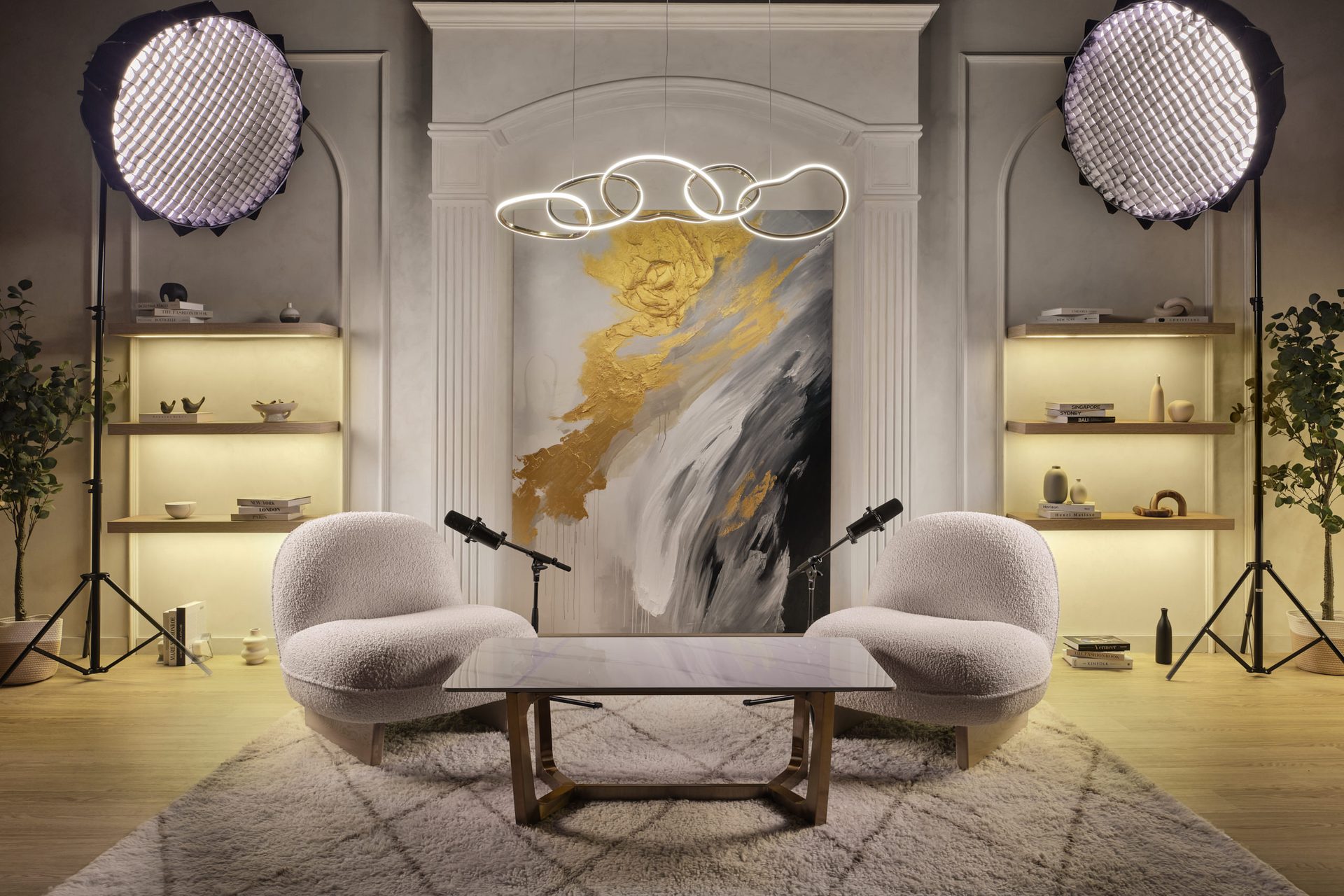 Luxury glam podcast studio with bouclé chairs, arched niche and LED chandelier