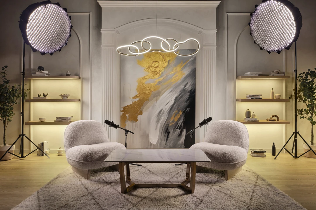 Luxury glam podcast studio with bouclé chairs, arched niche and LED chandelier
