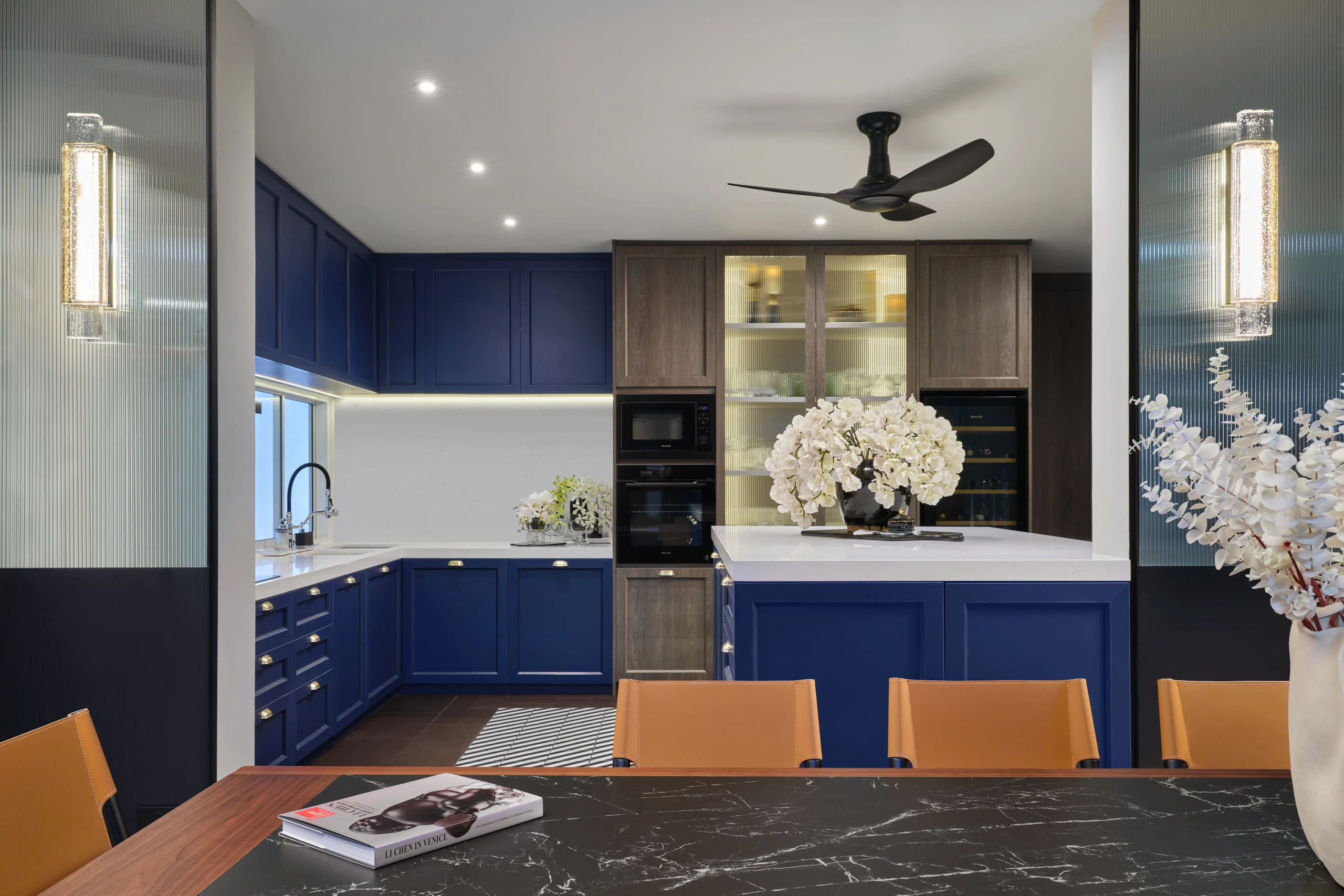 Living room with navy blue accent wall and built-in entertainment centre