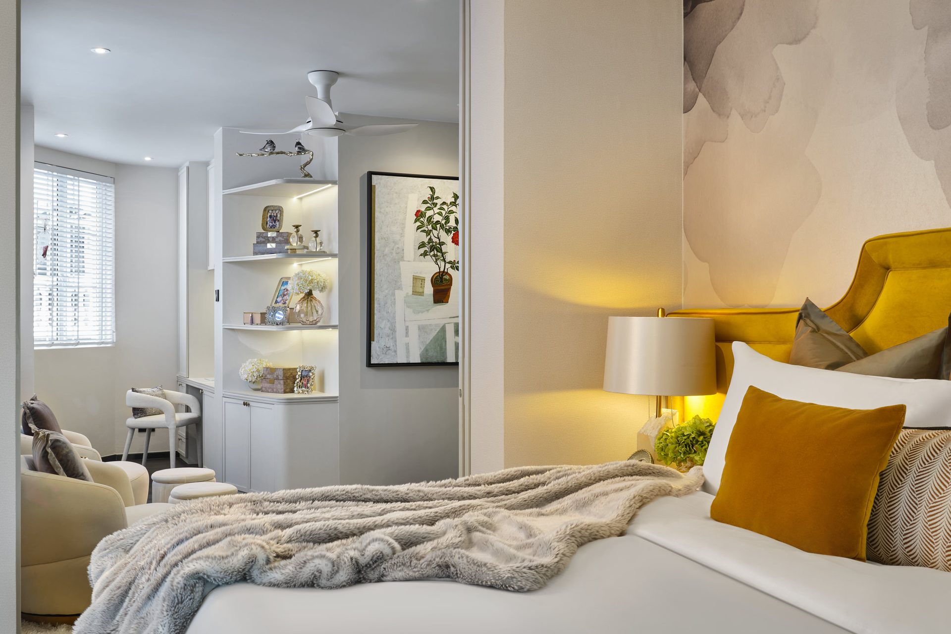 Modern bedroom with mustard accent pillows and built-in wardrobe storage