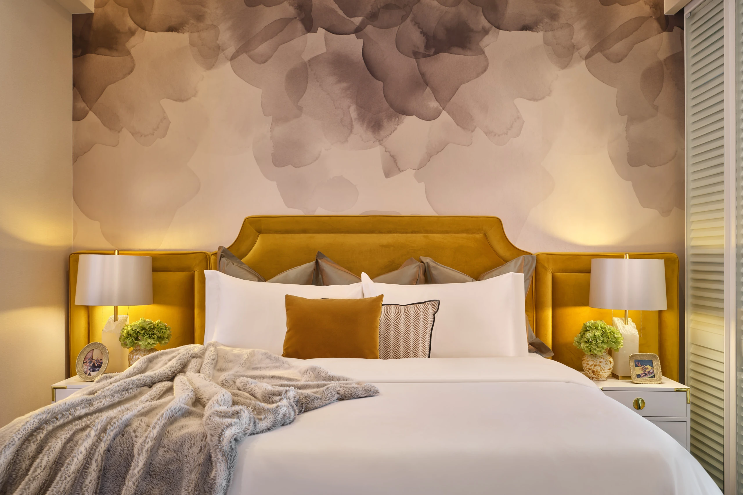 Bedroom with orange upholstered headboard and coordinated bedding