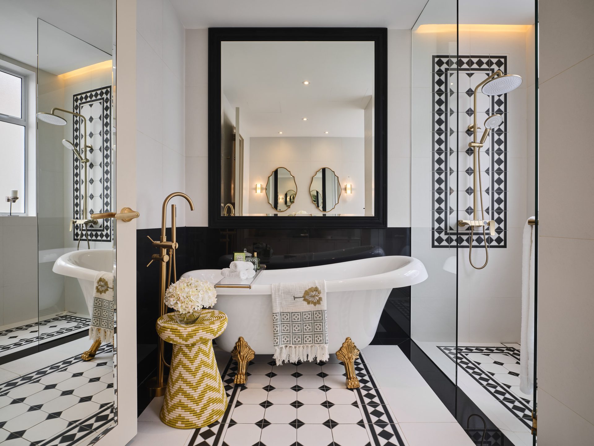 Bathroom with geometric floor tiles and dual round mirrors