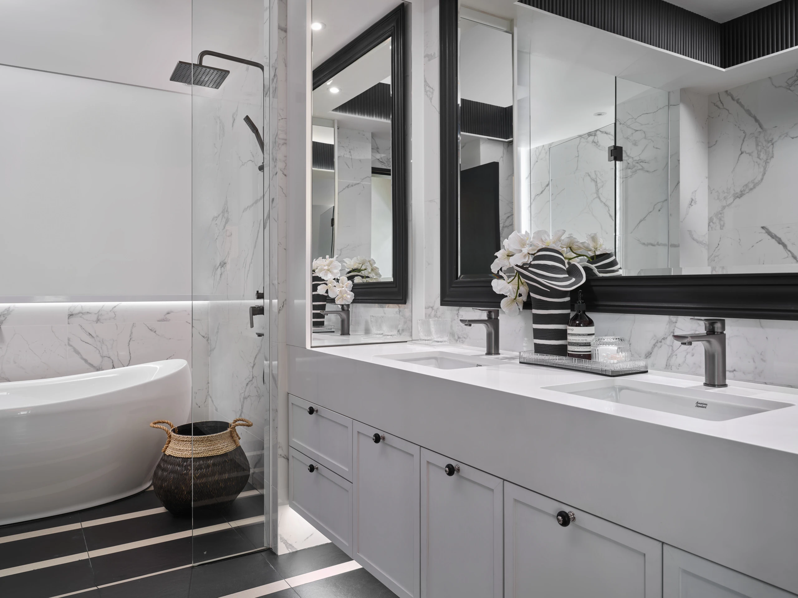 White bathroom with double vanity and marble countertops