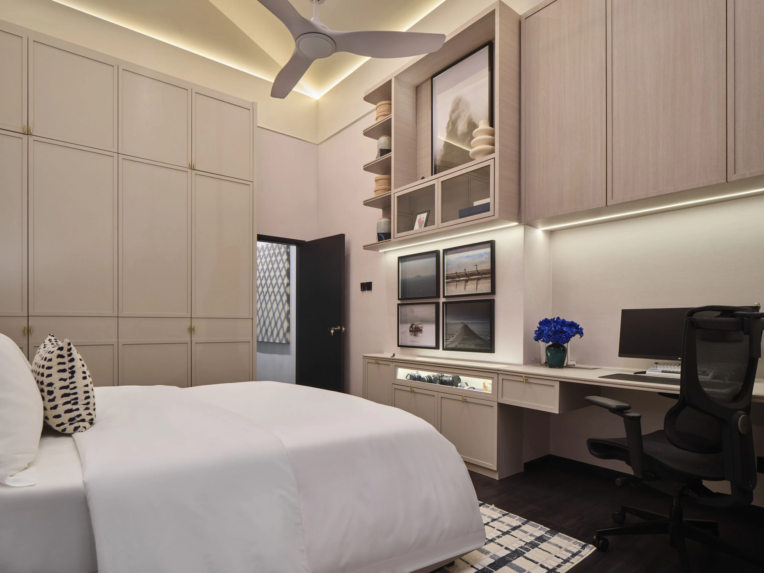 Bedroom with black built-in cabinetry and integrated LED lighting