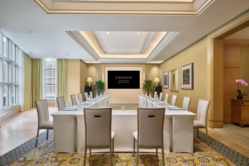Conrad Singapore Marina Bay Salon 4 in U-shape setup with intimate meeting room seating and soft hotel lighting