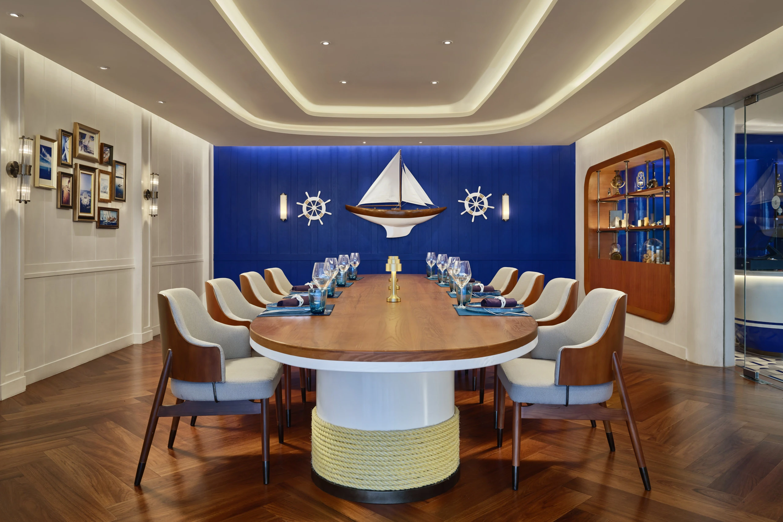 Private dining with sailboat model, ship wheels and rope-wrapped table — Siam Yacht Club Bangkok interior photography