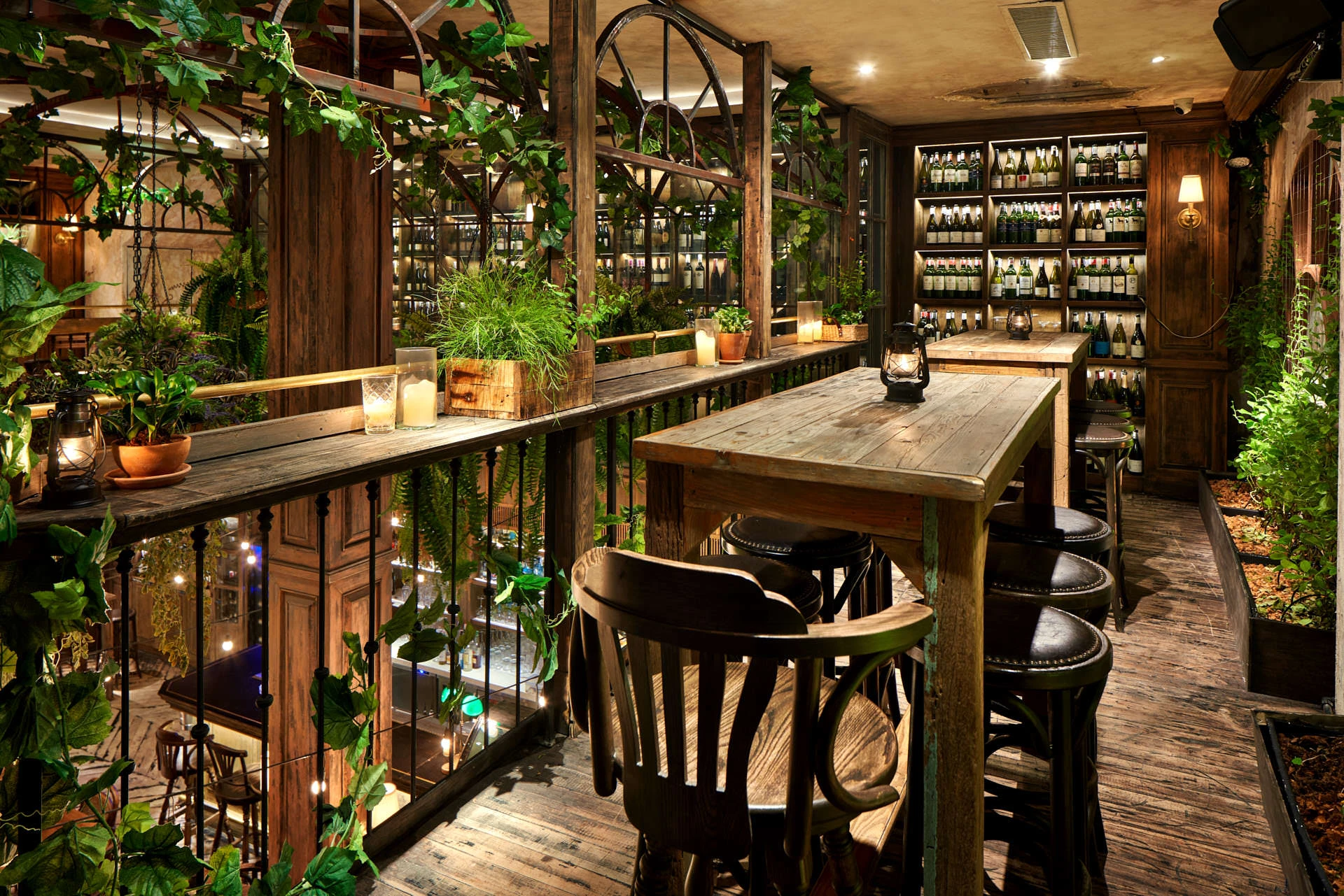 Mezzanine wine bar with reclaimed wood, bentwood stools and greenhouse arches