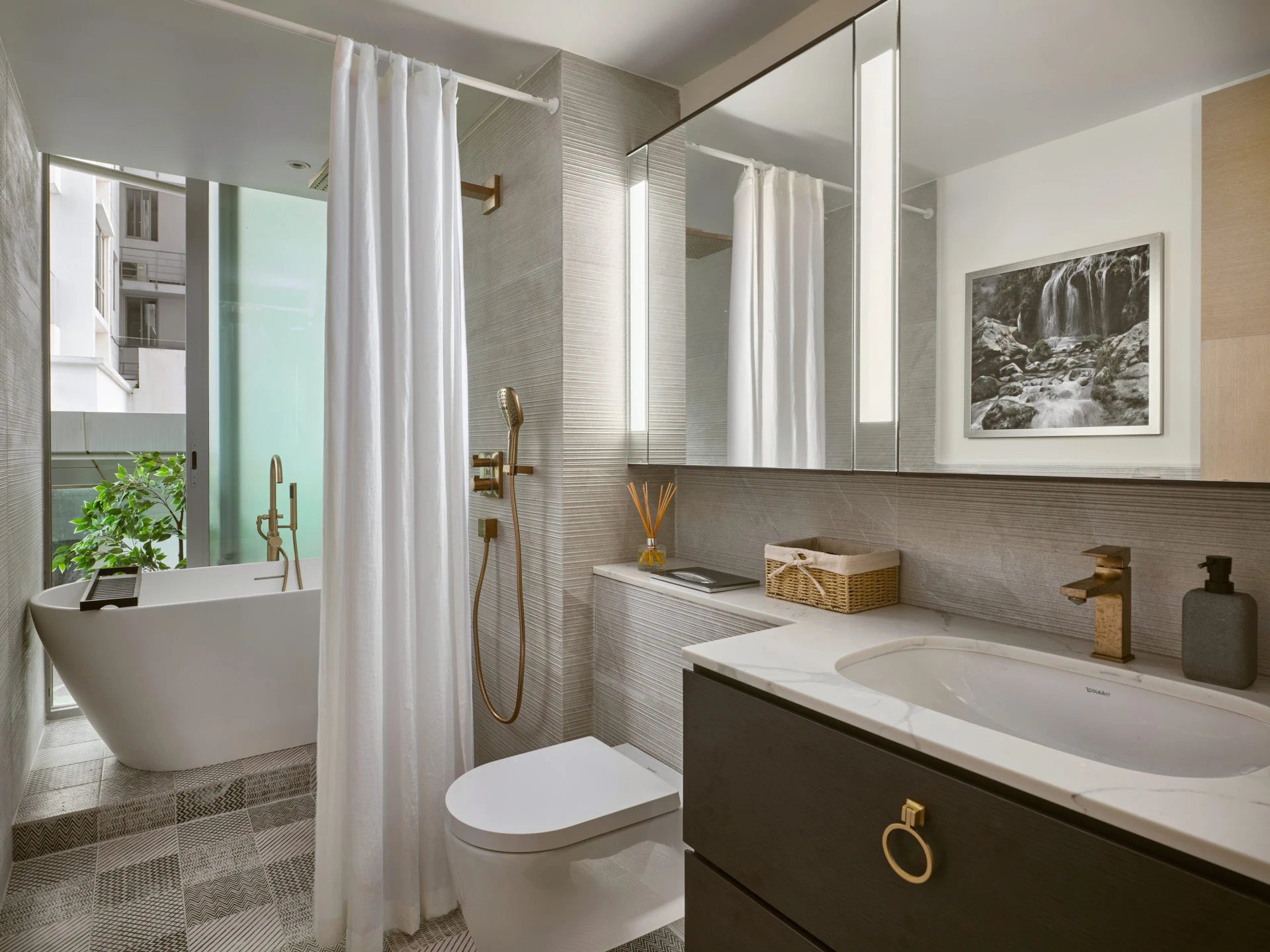 Spa bathroom with freestanding tub, marble vanity and geometric floor