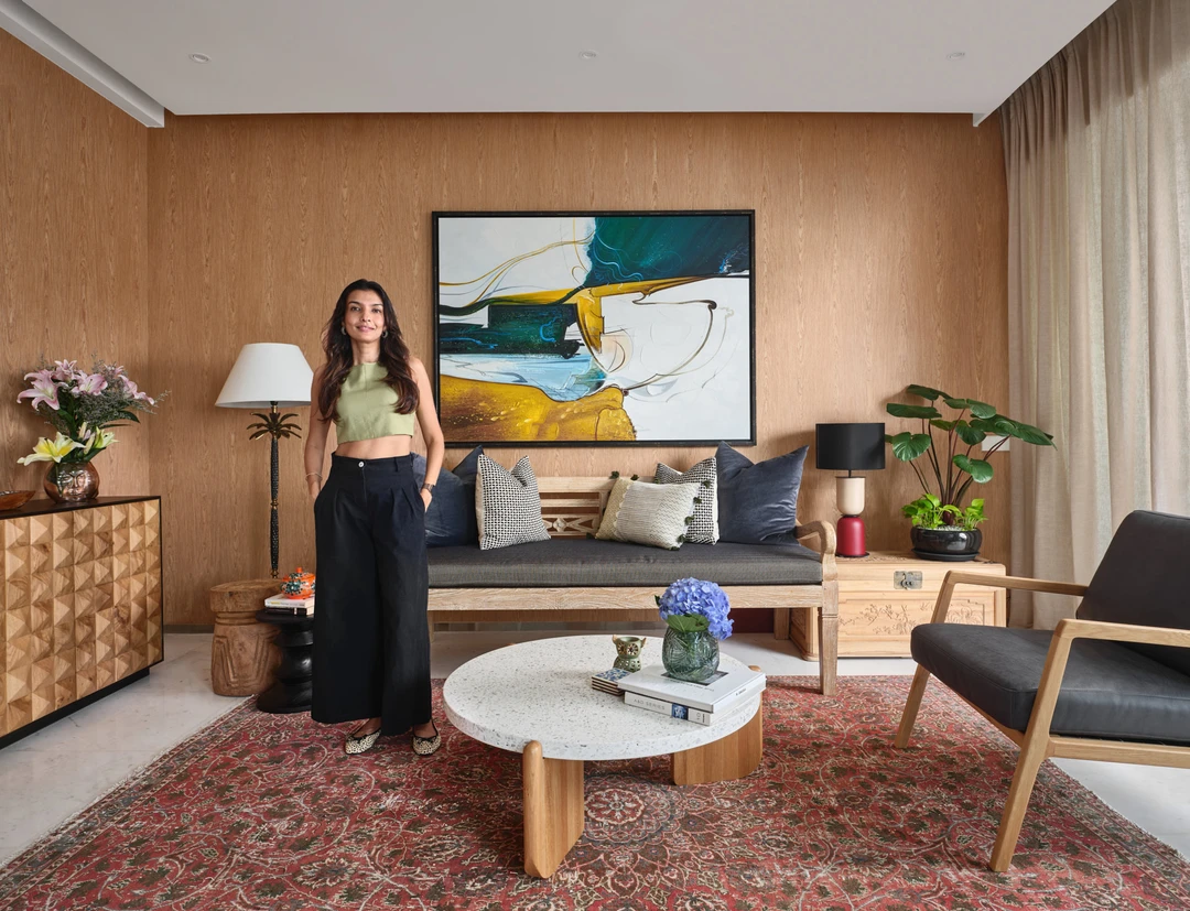 Interior designer portrait in living room with palm lamp and bold artwork
