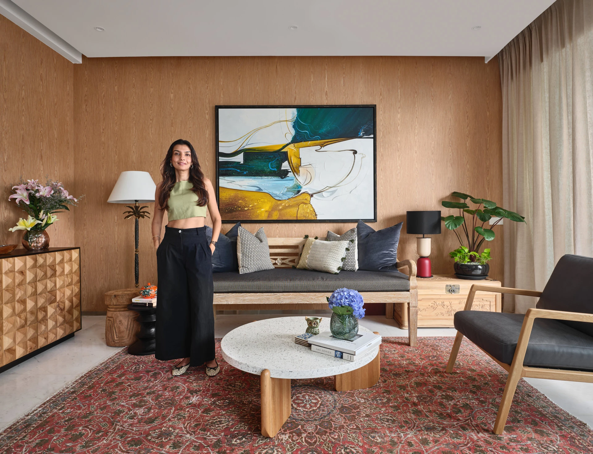 Interior designer portrait in living room with palm lamp and bold artwork