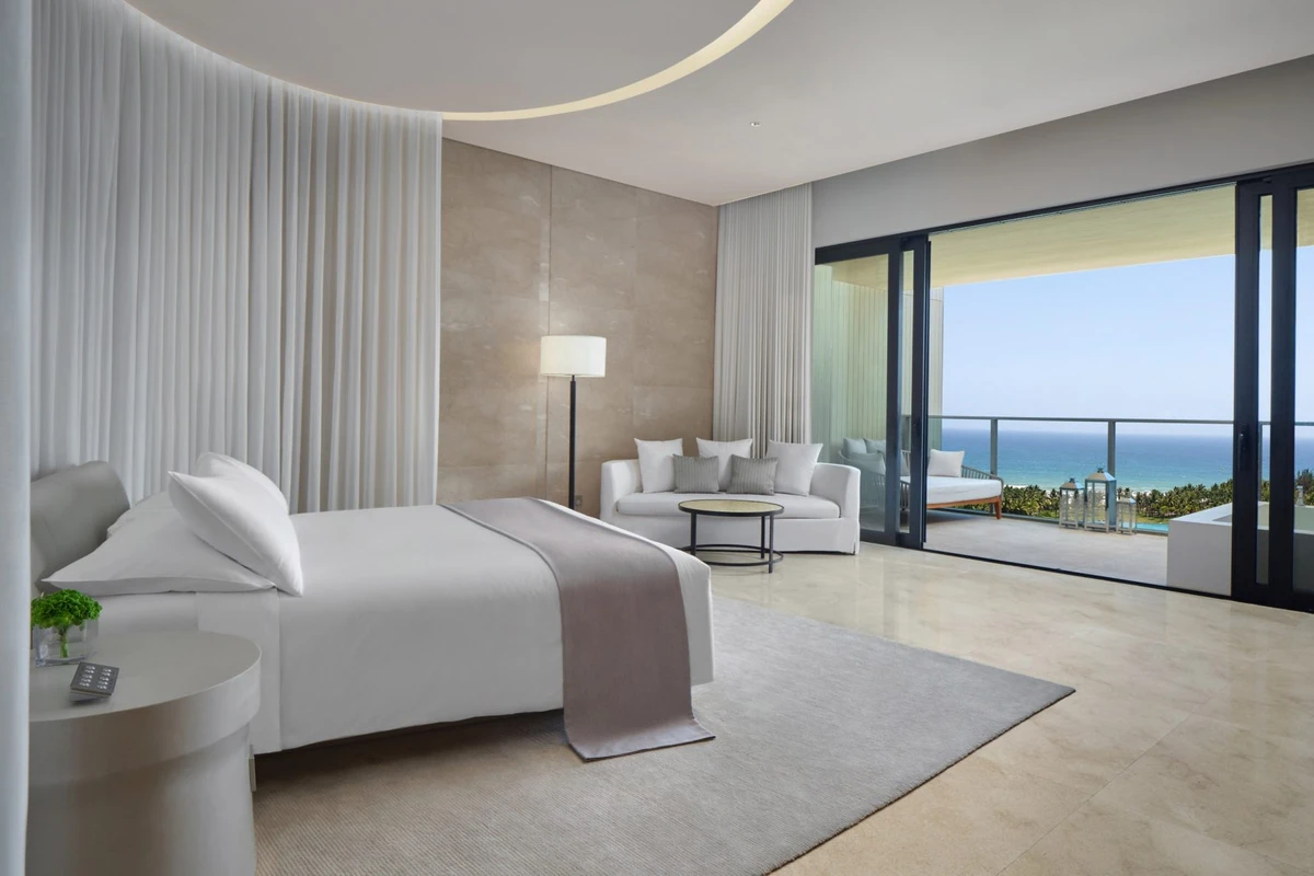 The Sanya EDITION loft room with oceanfront canopy draping and sea view balcony