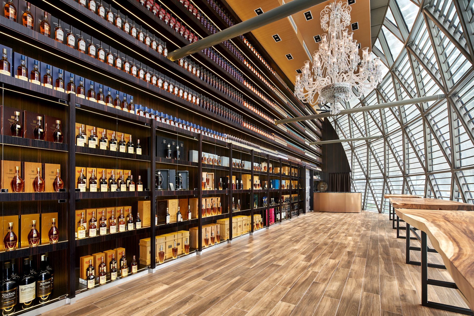Grande hall with towering whisky wall, crystal chandelier and glass atrium