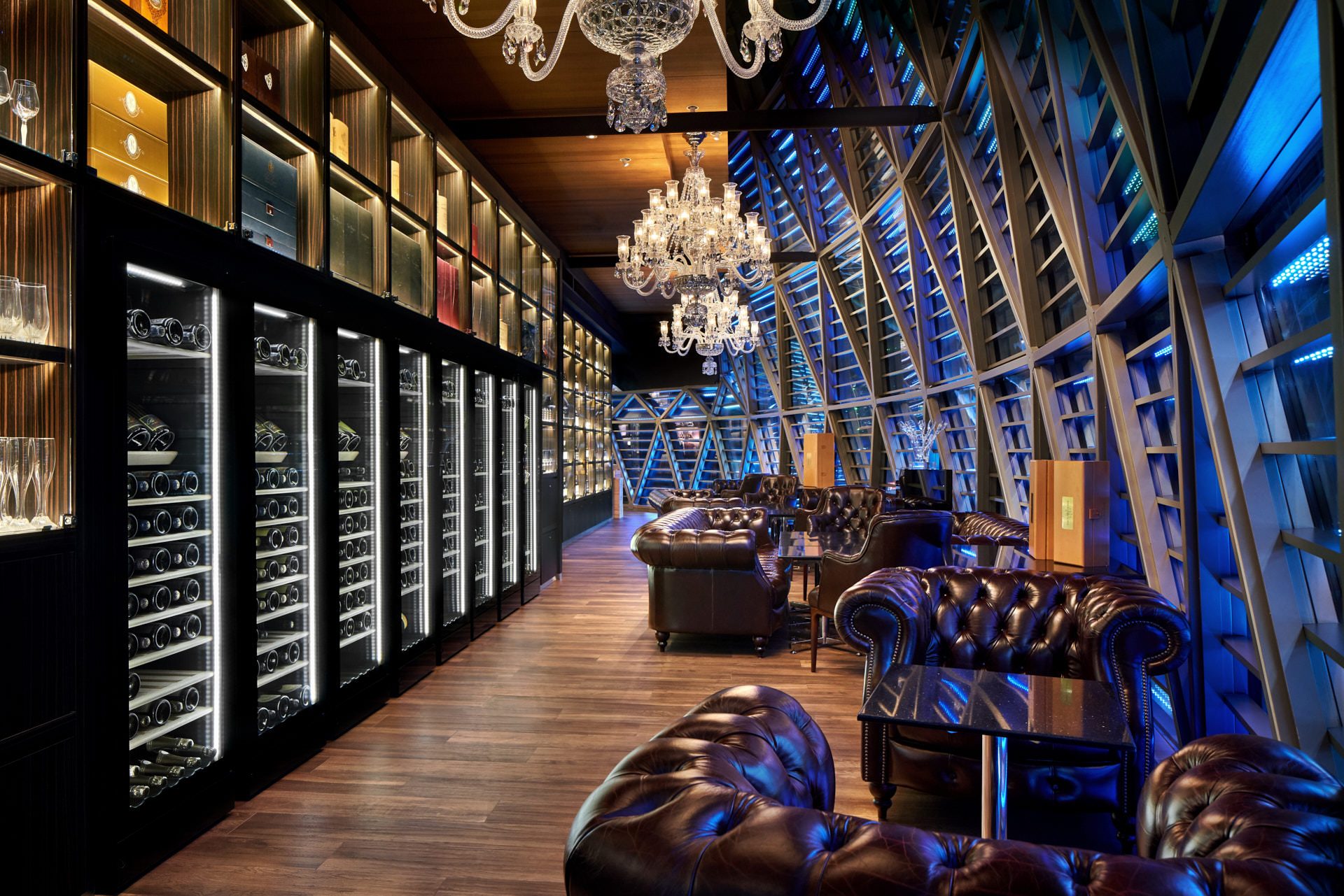 Champagne lounge with Chesterfield chairs, crystal chandeliers and wine cabinets