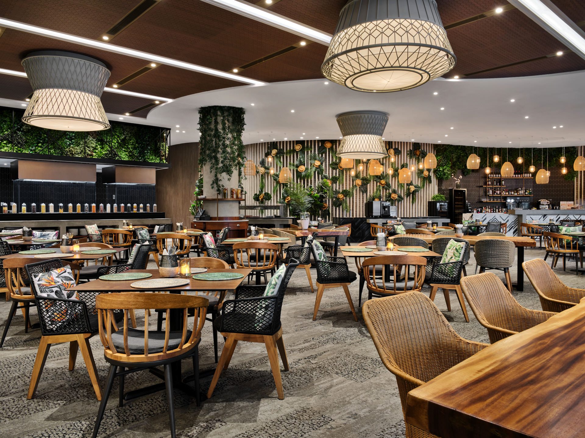 Tropical dining room with living walls, basket pendants and rattan chairs — Village Hotel Sentosa restaurant photography
