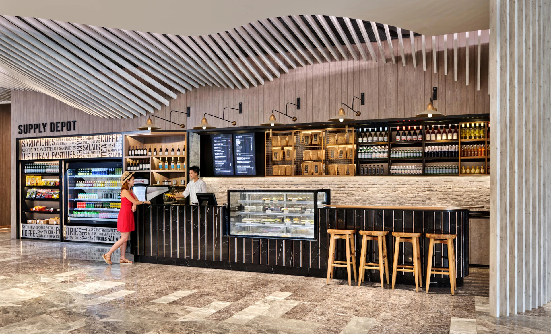 Supply Depot cafe with guest at counter and curved timber ceiling — Village Hotel Sentosa hospitality photography