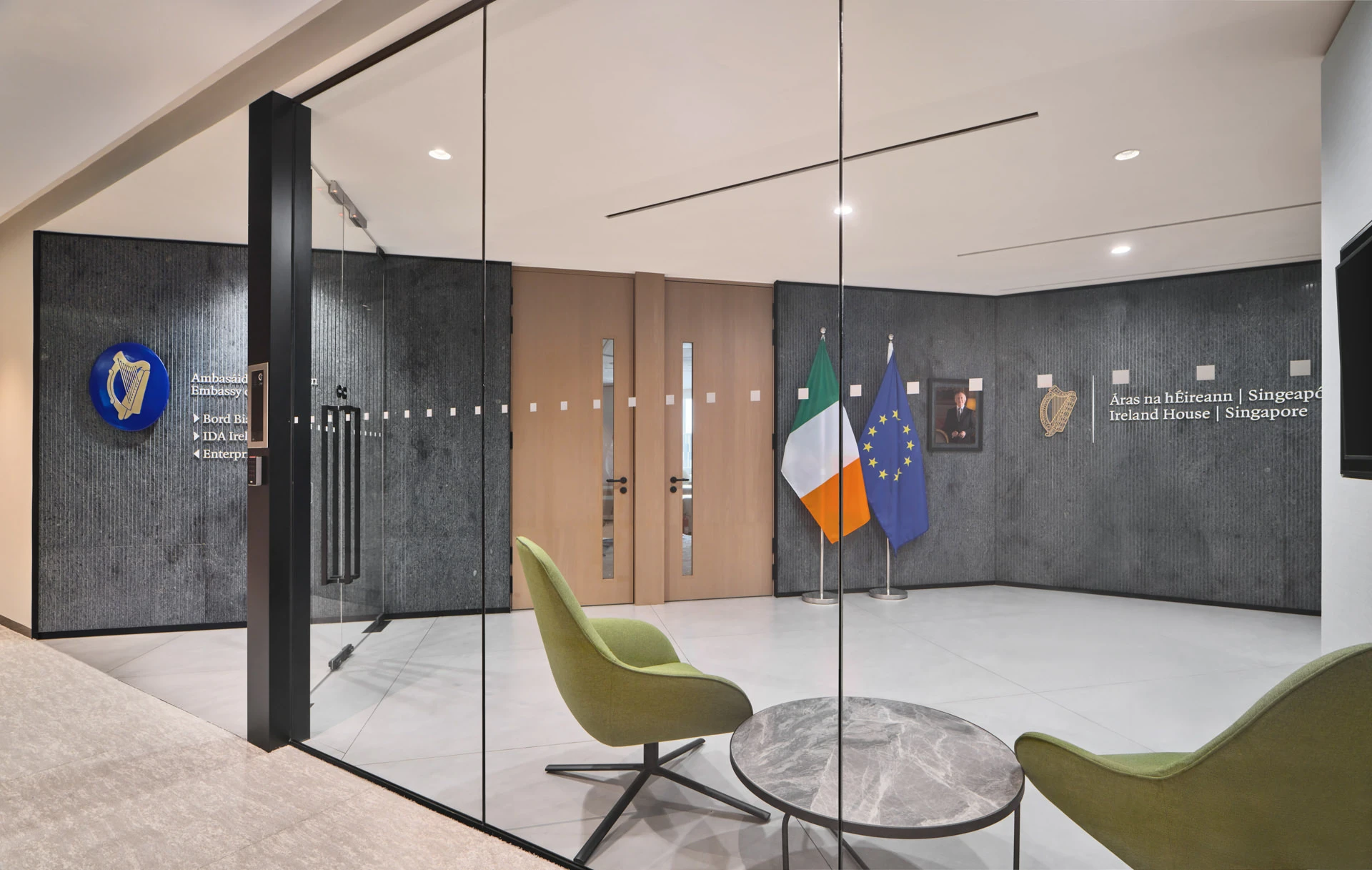 Ireland House Singapore reception with stone walls and frameless glass