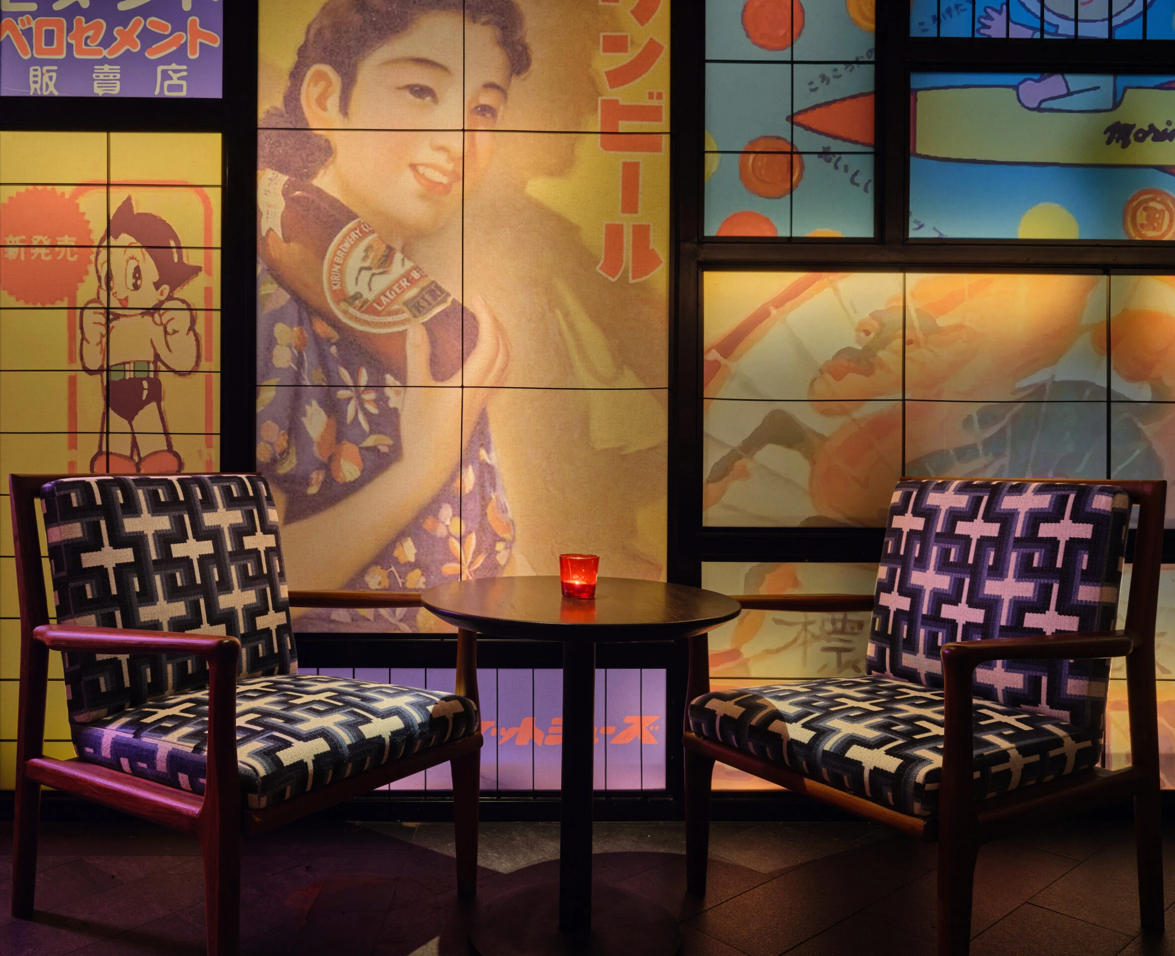 Corner booth with bold print cushions and framed pop art