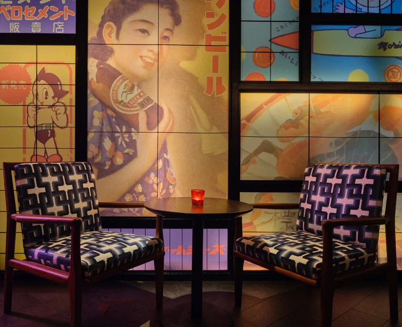 Corner booth with bold print cushions and framed pop art