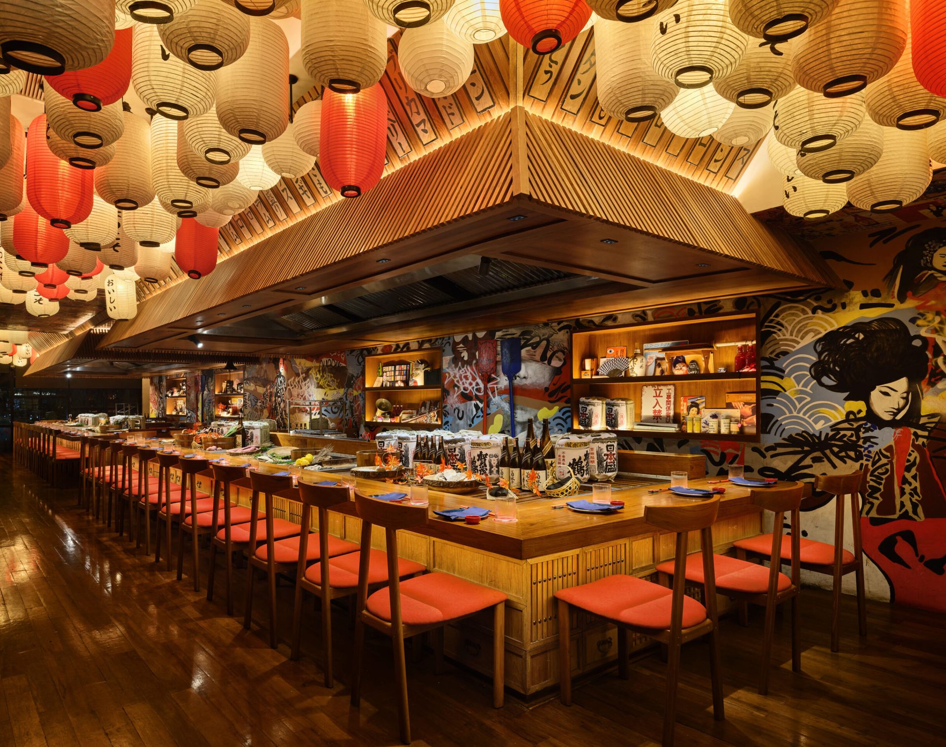 Upstairs dining room with paper lanterns, warm timber and robata counter
