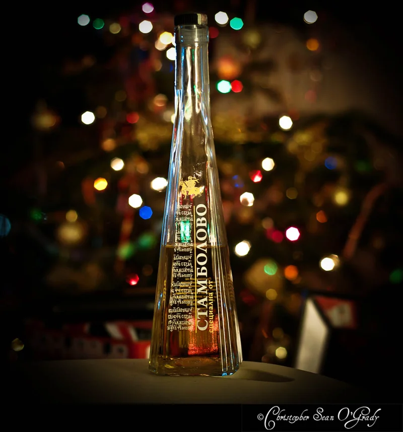 Stambolovo Bulgarian rakia bottle with colourful Christmas tree lights in background