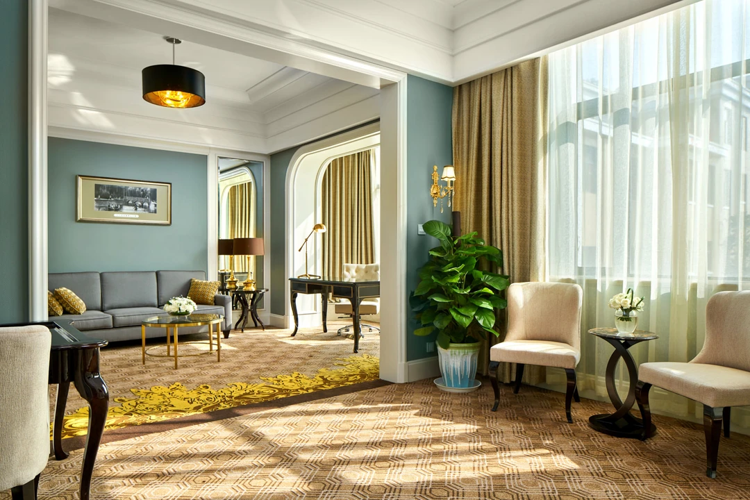 Club suite in duck-egg blue with arched doorways and gold drapery — Crowne Plaza Zhengzhou hospitality photography