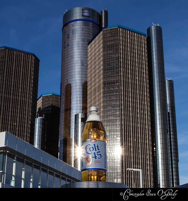 Colt 45 malt liquor 40oz bottle at Detroit Renaissance Center at dusk